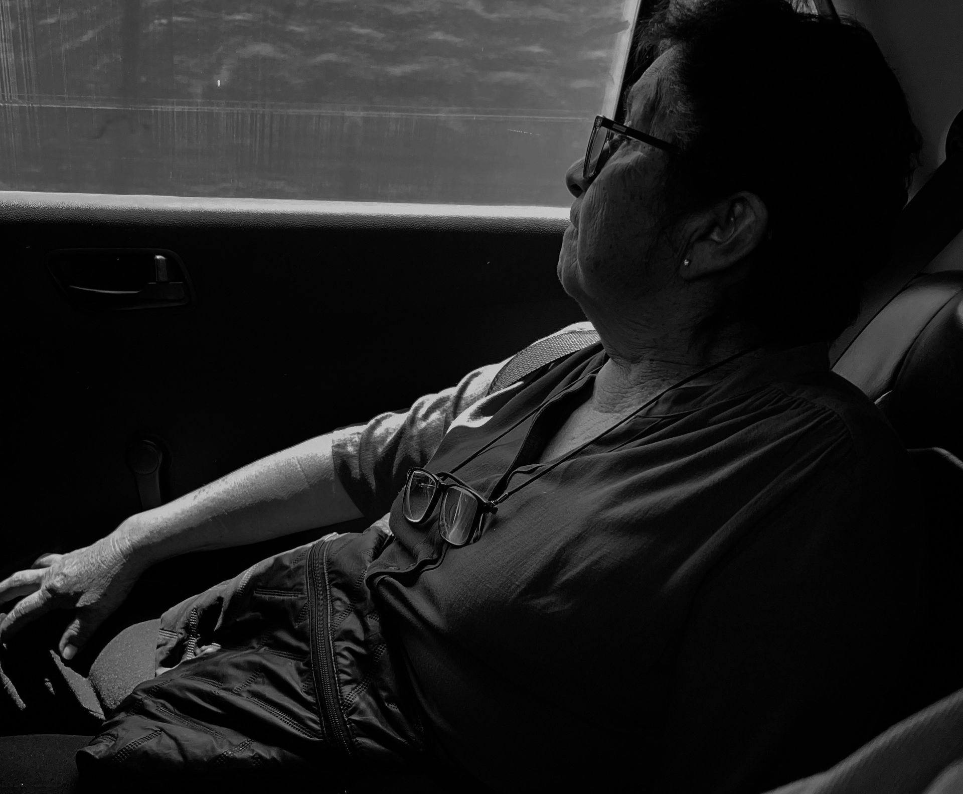 Woman looking out window of a moving vehicle
